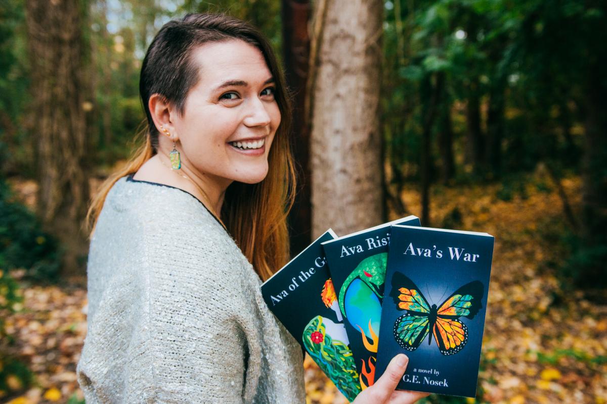 Grace Nosek with her teen eco-fantasy novel series, Ava of the Gaia