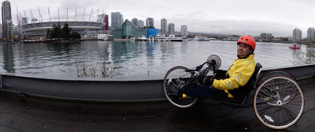 Dr. Raju, visiting Canada in 2016, tries his skill on a handcycle in Vancouver. He attended a resident review course in Toronto and toured two rehab hospitals, including Vancouver's GF Strong