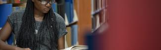 Student reading a book in the library (Photo: UBC Brand & Marketing) 